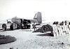 Supplies being unloaded from USAF C-47, #349035,  on 5 December 1950 at Hagaru-ri air strip, Chosin Reservoir, N. Korea. Dead in sleeping bags (lower left) await evacuation. Photo by Sgt. W.R. Keating, USMC.
Bill Brennen