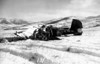 This is the wreckage of a Navy TBM torpedo bomber of WW II vintage, at the Hagaru-ri airstrip. It was borrowed by Marine Observation Squadron 6 ( VMO-6), and their pilots used it to resupply and evacuate wounded from the emergency air strips at Hagaru-ri and Koto-ri near the Chosin Reservoir N. Korea, before the strips were made long enough to accomodate the larger R4D and C-47 transport aircraft. I don't know the details of its demise.
Bill Brennen, USMC, Hq. Sq. M.A.G. 33 1949-1951 billnm@sbcglobal.net